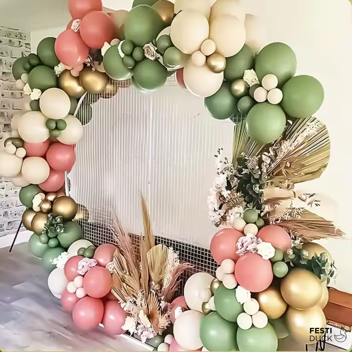 Balloon arch backdrop styled with gold and green balloons